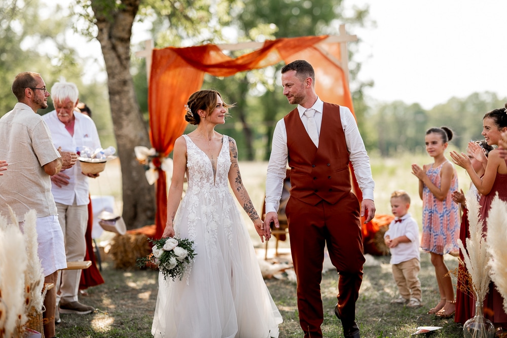 Les mariés quittent leur cérémonie laïque sous les applaudissements de leurs proches en Haute-Savoie, photographiés par une photographe de mariage en Haute-Savoie